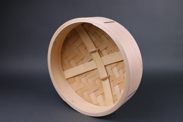  frontal interior view of hinoki and bamboo lid for steamer with heavy duty construction of slats and a dense bamboo weave in front of grey backdrop
