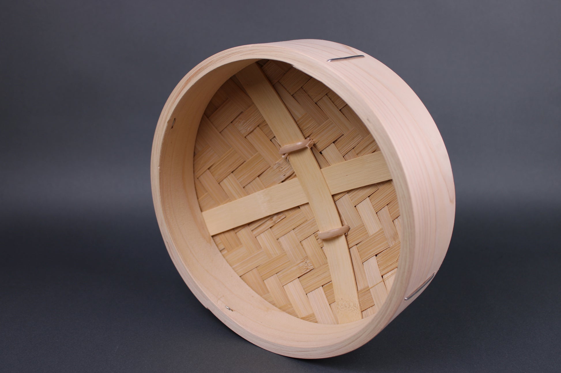 frontal interior view of hinoki and bamboo lid for steamer with heavy duty construction of slats and a dense bamboo weave in front of grey backdrop