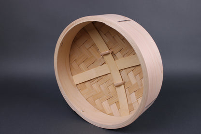  frontal interior view of hinoki and bamboo lid for steamer with heavy duty construction of slats and a dense bamboo weave in front of grey backdrop