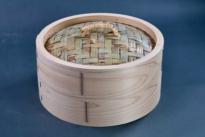 Ebematsu Shoji 27cm kiso hinoki bamboo steamer lid showing woven bamboo weave pattern and rattan handle on grey background