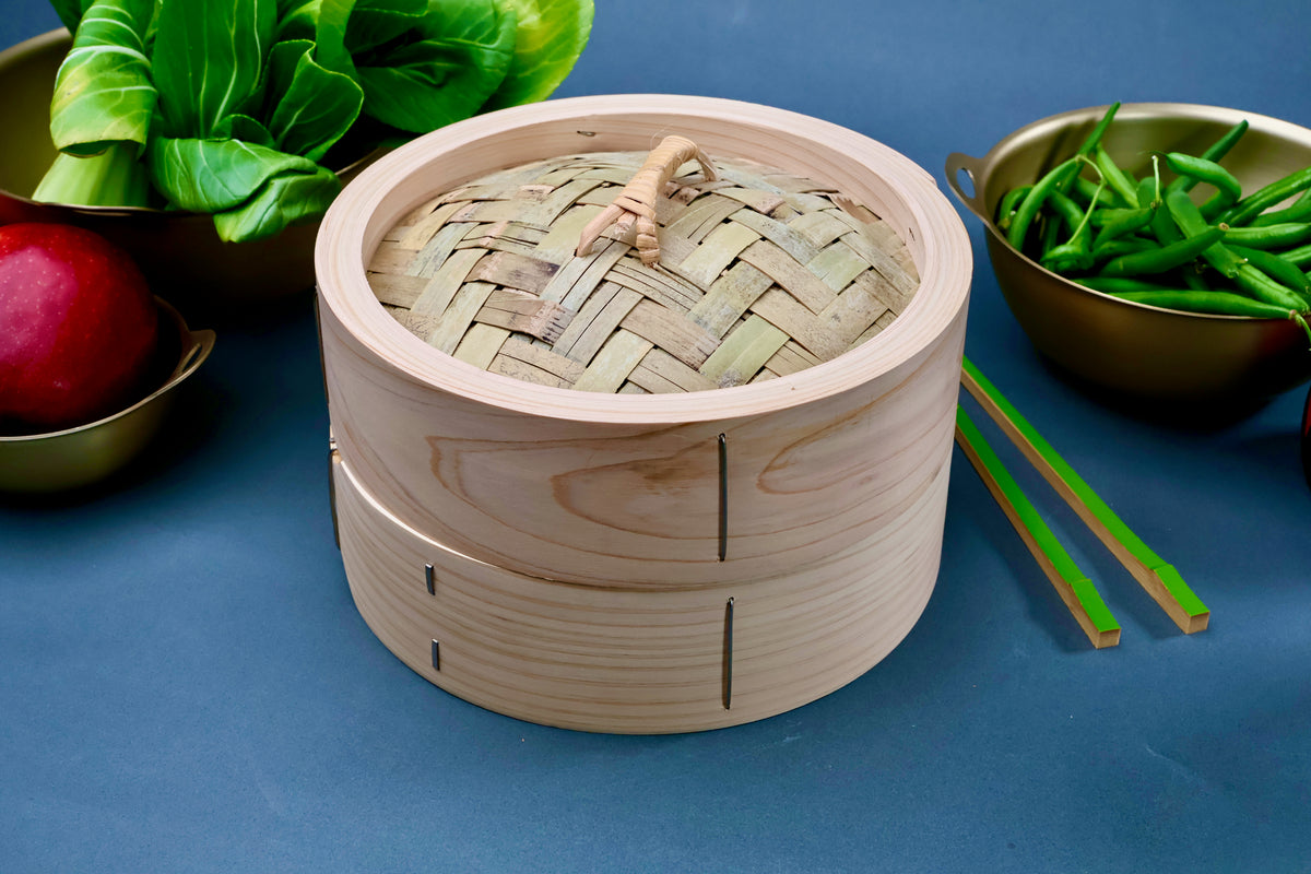 Ebematsu Shoji Kiso Hinoki bamboo steamer set 21cm front view styled with fresh vegetables and saibashi on blue background