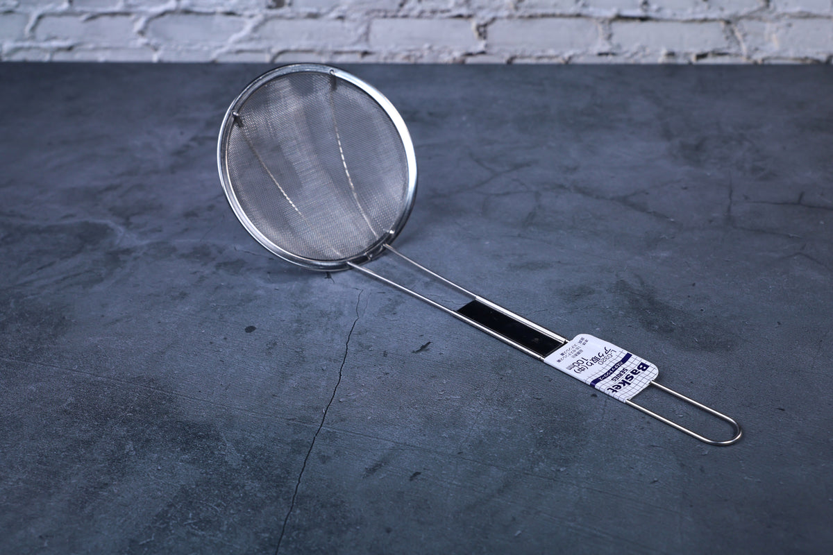 Fine mesh skimmer — full view of fine mesh basket, handle, and stainless construction on concrete