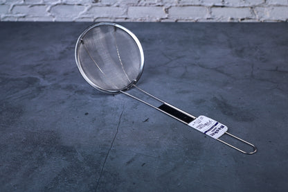 Fine mesh skimmer — full view of fine mesh basket, handle, and stainless construction on concrete