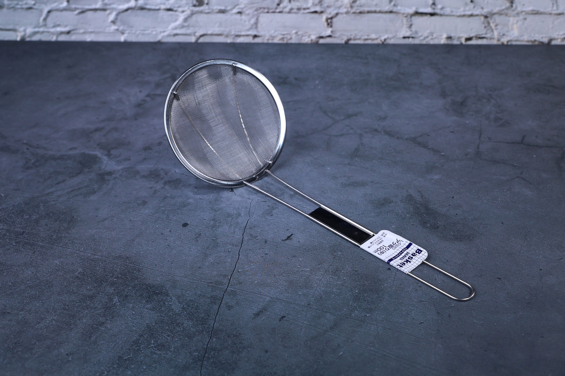 Fine mesh skimmer — full view showing fine wire mesh basket, stainless rim, and Japanese product label