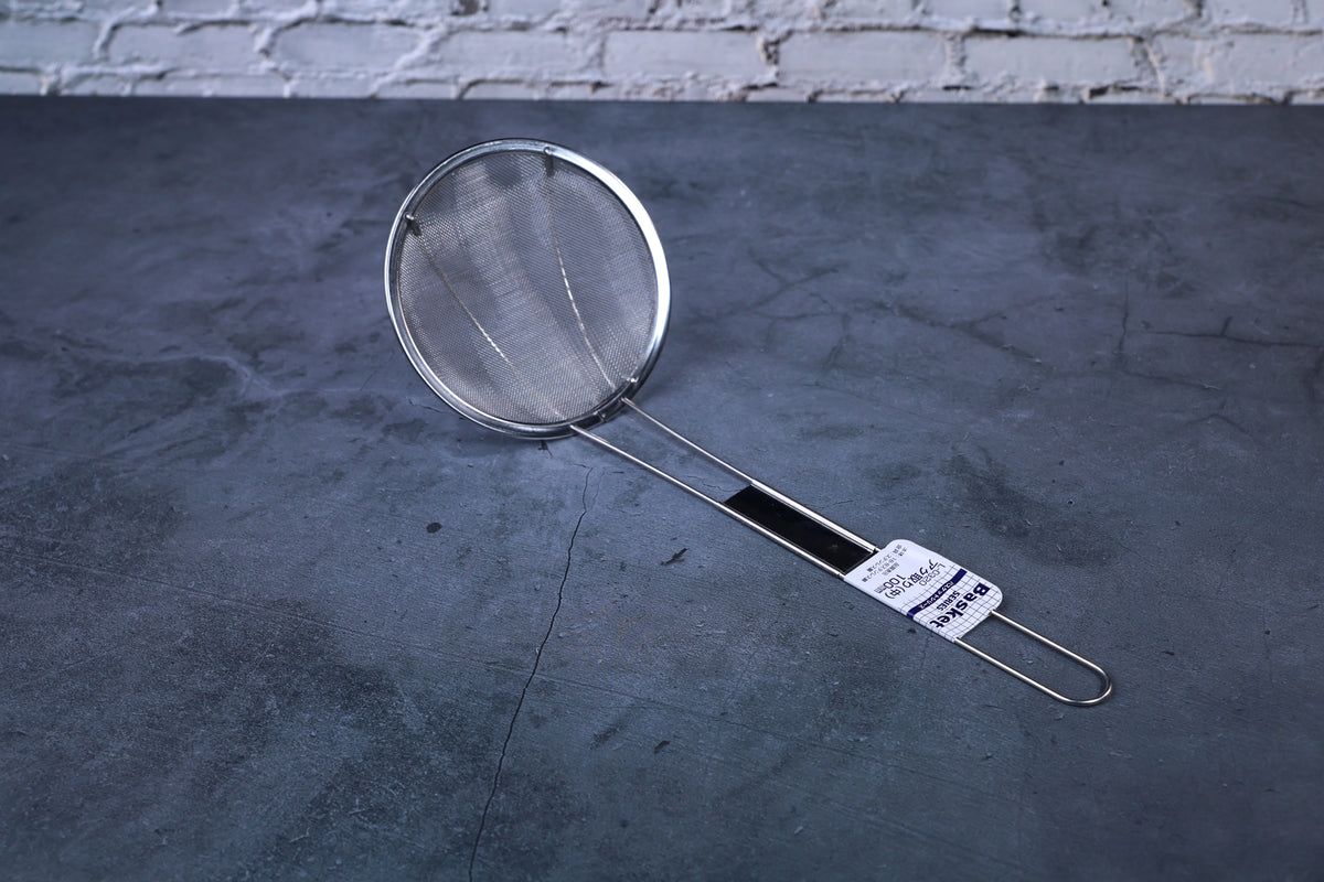 Fine mesh skimmer — full view showing fine wire mesh basket, stainless rim, and Japanese product label
