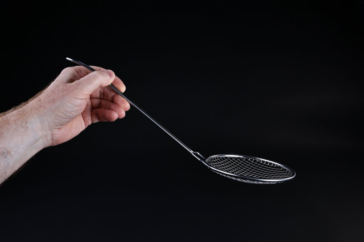 Fujiboshi fried food skimmer — side profile showing curved basket depth and long handle angle in hand