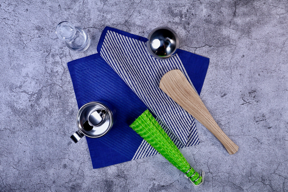 Hamamonyo classified stripes blue tenugui styled on concrete with kitchen tools, showing real-use context