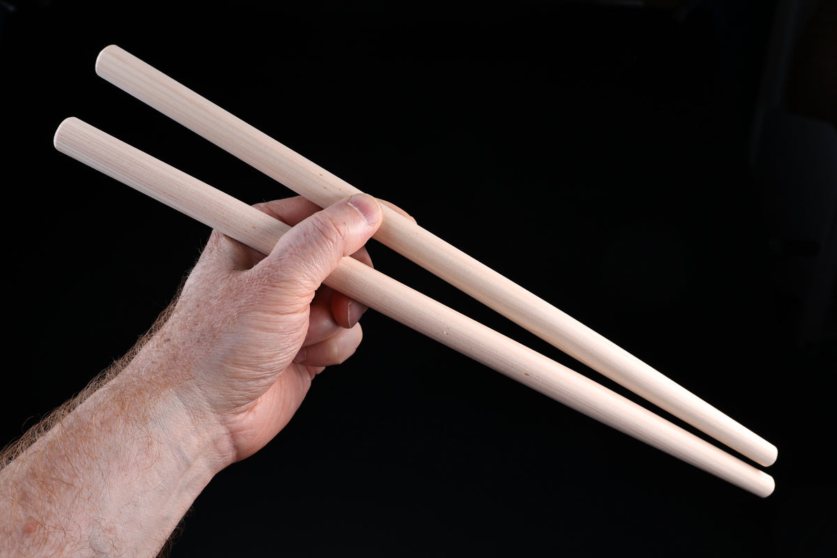 Hanabashi tempura chopsticks 36cm — side view in hand showing full length and round profile