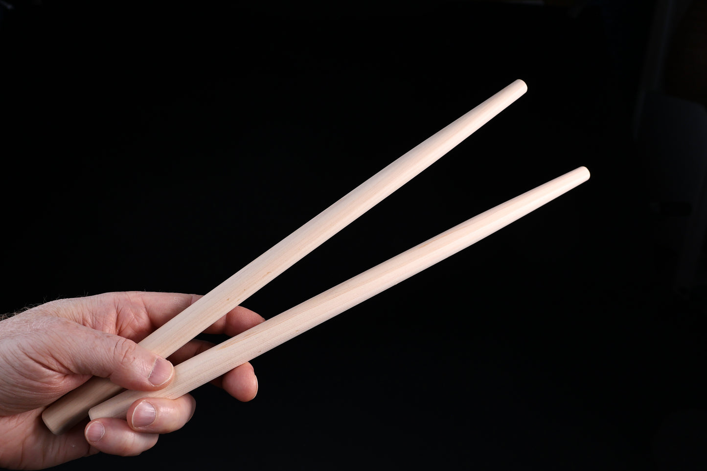 Hanabashi tempura chopsticks 36cm — held in hand showing grip position and tapered tips
