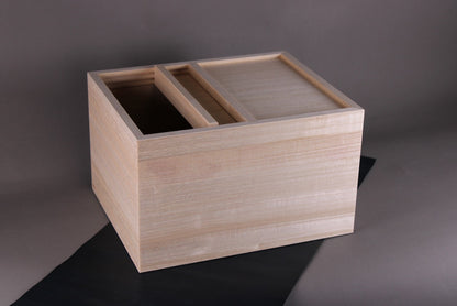 azmaya rice bin made of paulownia wood showing top sliding door open atop dar blue strip with grey background