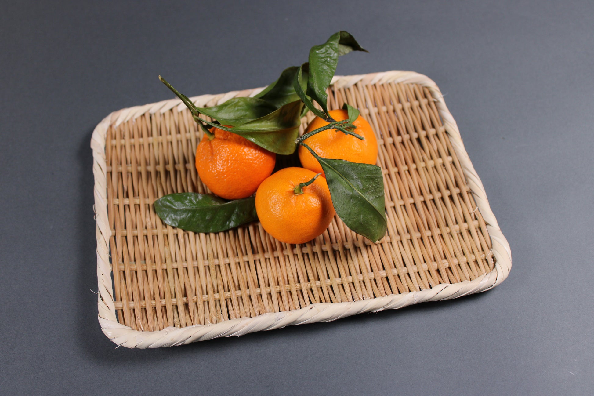 rectangle shaped handmade bamboo plate 21cm from Sado Japan with grey background