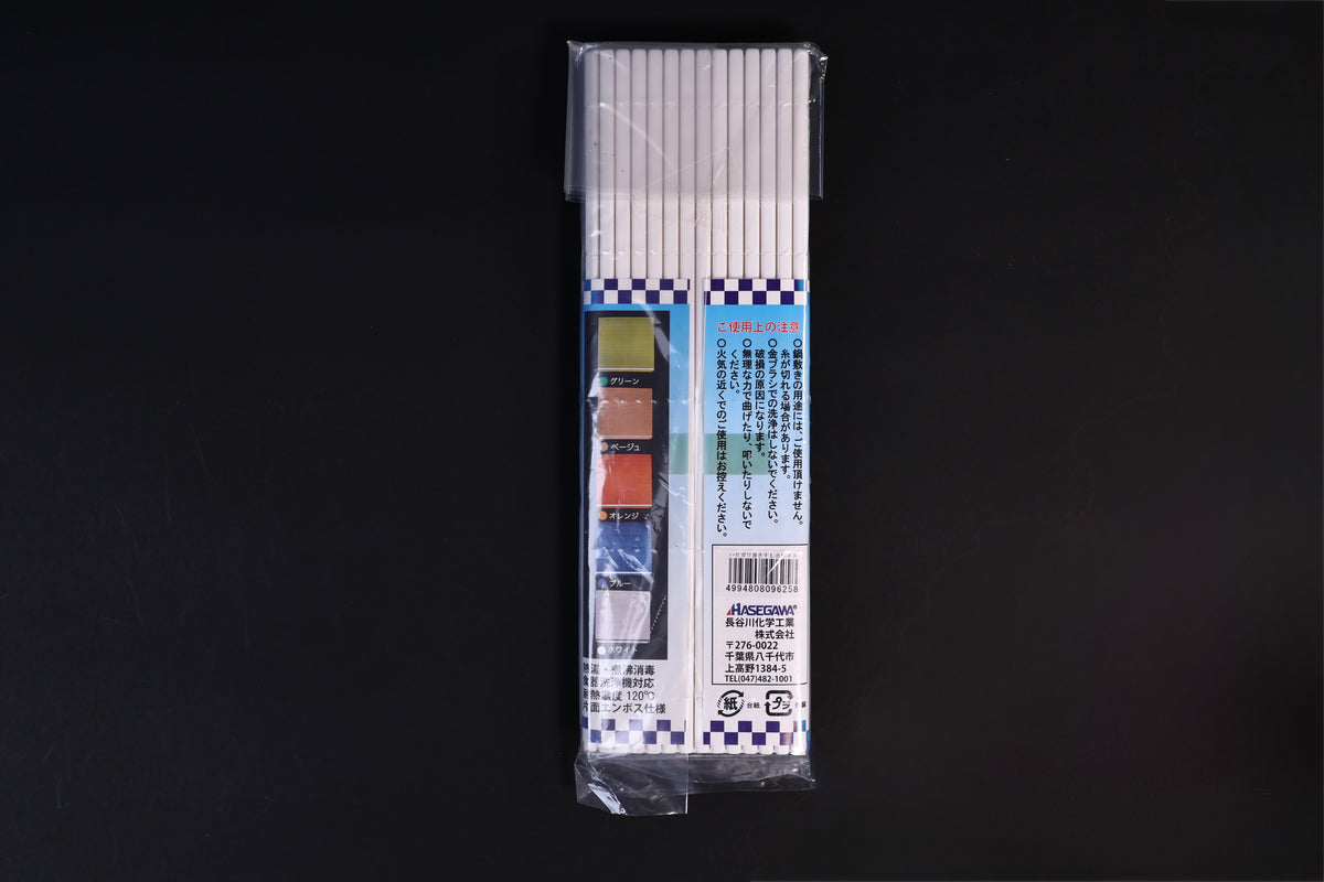 Back of the Hasegawa white sushi rolling mat size L package laid flat on a dark background
