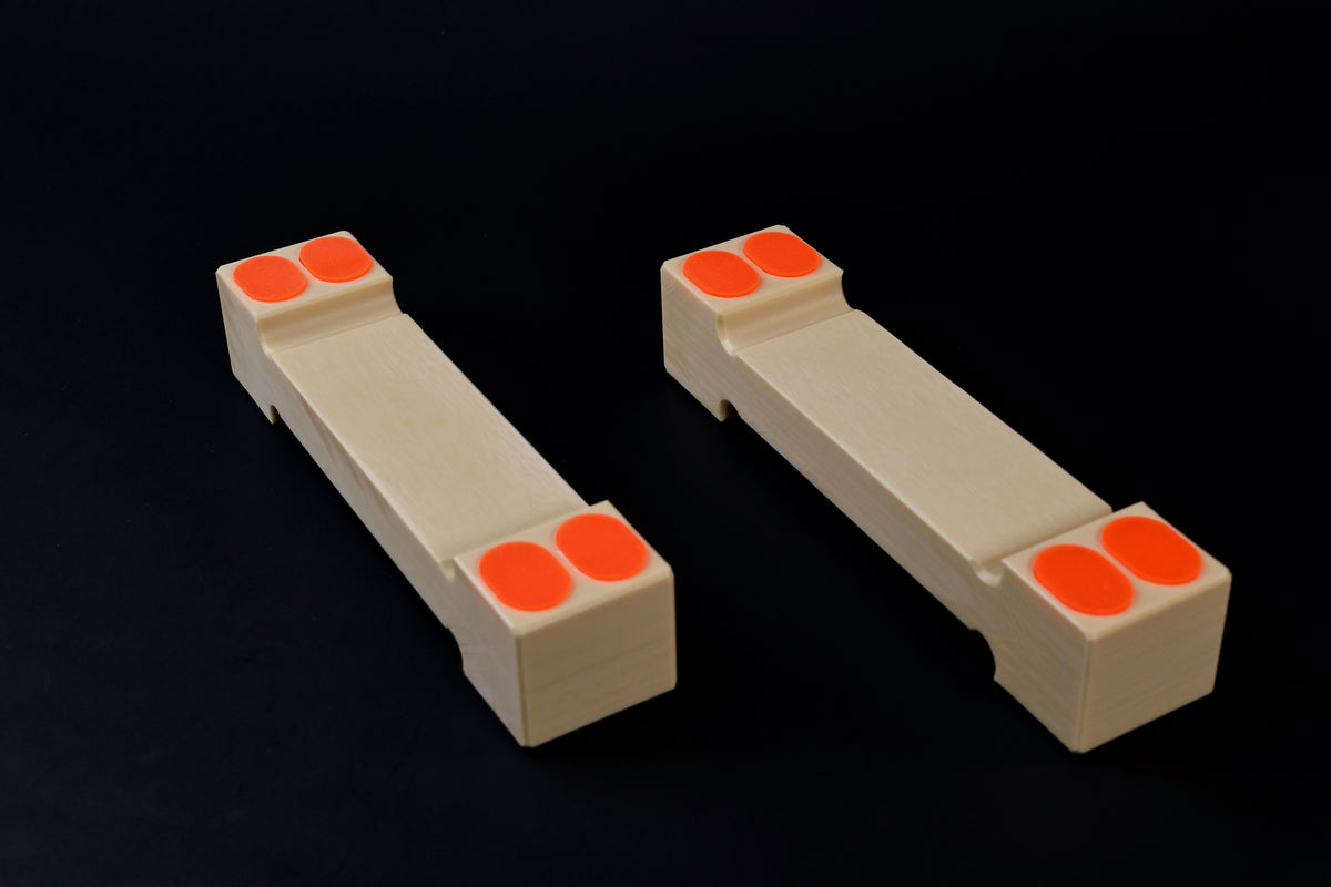 Hasegawa cutting board lifter large — pair at diagonal showing double orange grip pads and wider body
