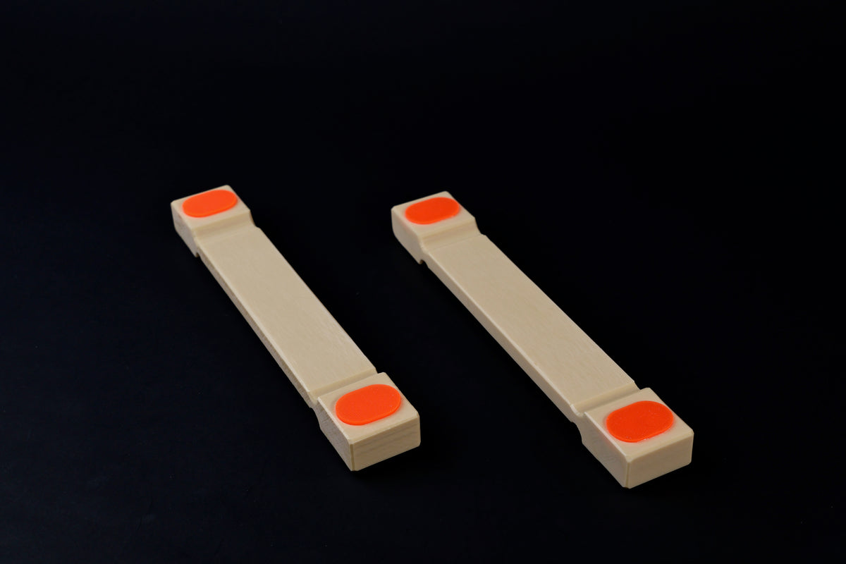 Hasegawa cutting board lifter small — pair side view showing low-profile body and recessed grip pad ends