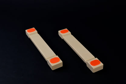 Hasegawa cutting board lifter small — pair side view showing low-profile body and recessed grip pad ends