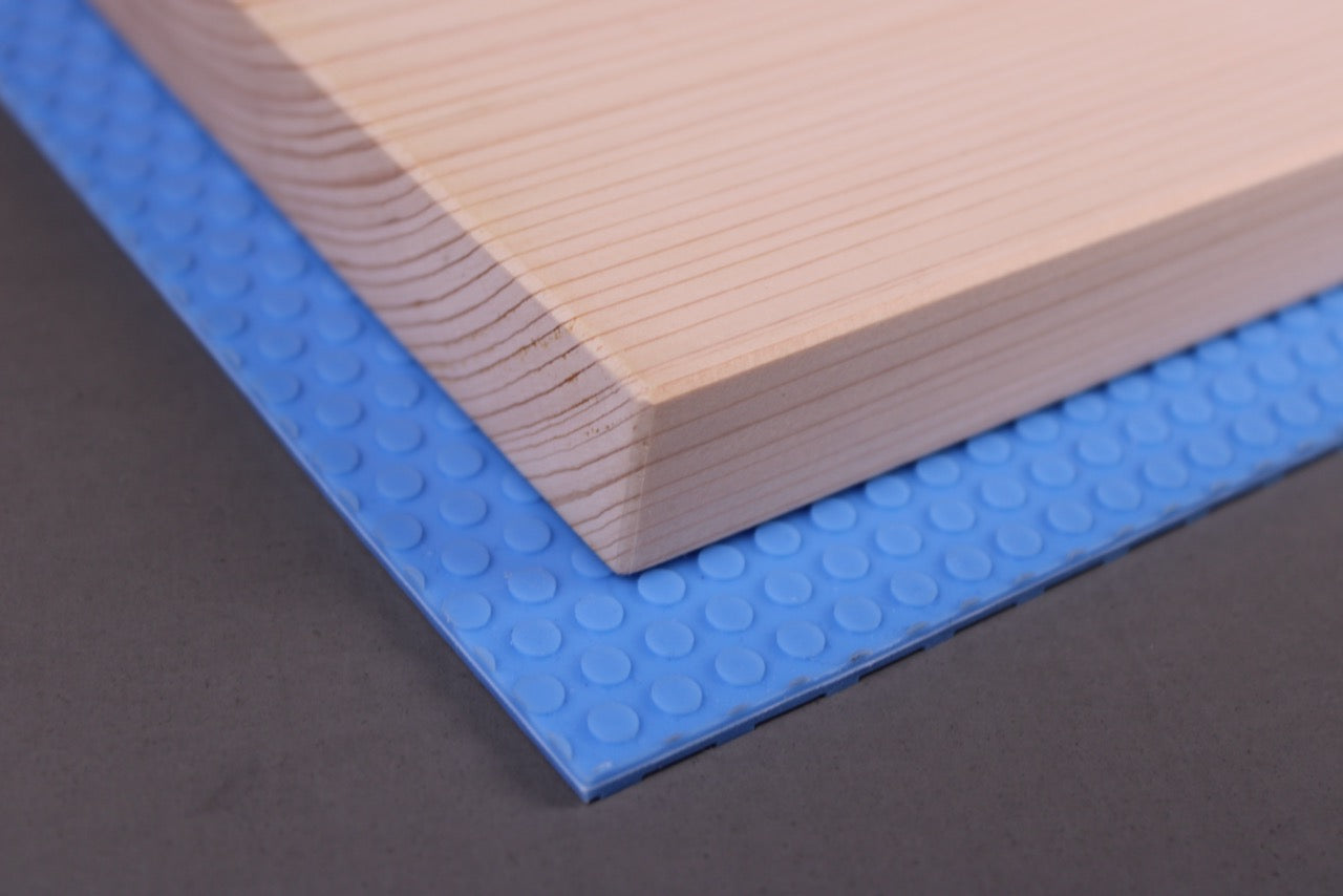 close up hinoki cutting board over blue hasegawa nonslip hygienic mat