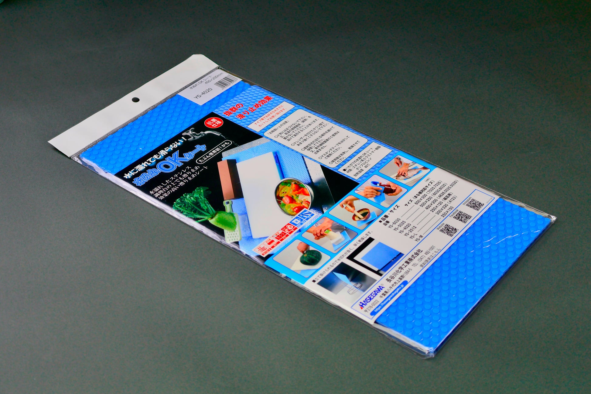 rectangular bright blue embossed mat in plastic product package with white top stripe upc barcode bright hiragana writing and food images on dark grey background