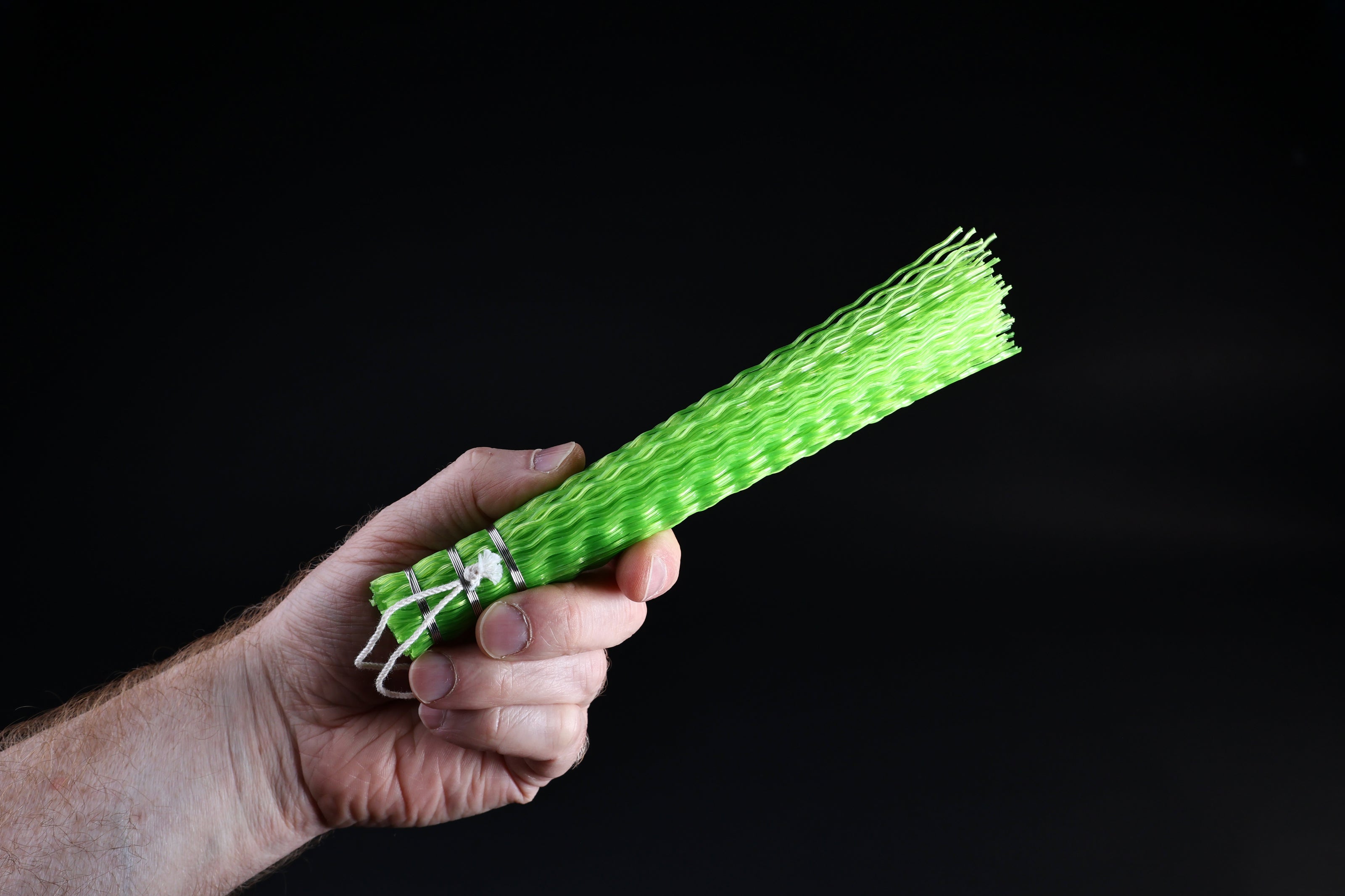 Hayakawa sasara fish cleaning brush — bristle end and crimped plastic texture held in hand