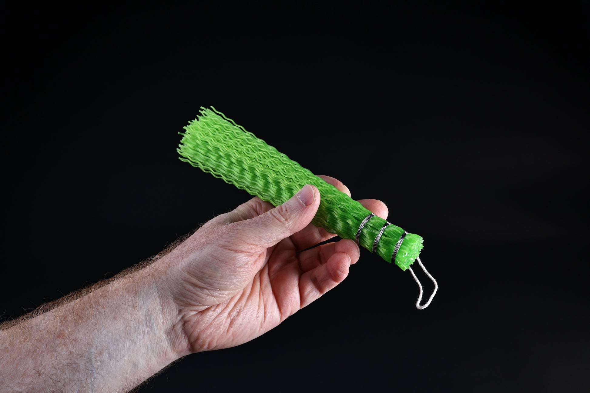 Hayakawa sasara fish cleaning brush — full length side profile showing bristle spread and handle in hand