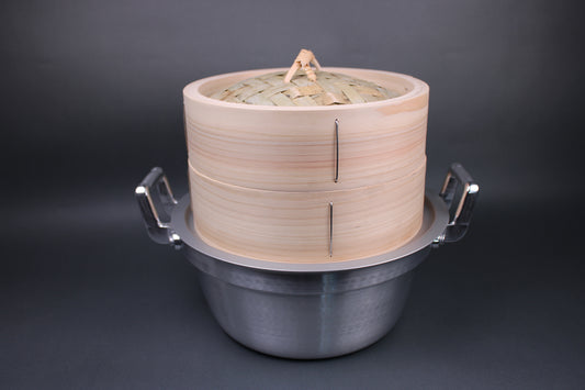 frontal shot of kiso hinoki japanese steamer lid and base sitting on steam ring and a two handled steamer pot 24cm steamer is also made of bamboo and is thick and durable