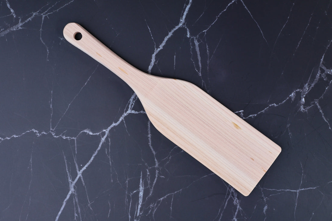 Hinoki wood spatula large — top view showing full blade, grain, and hanging hole on marble surface