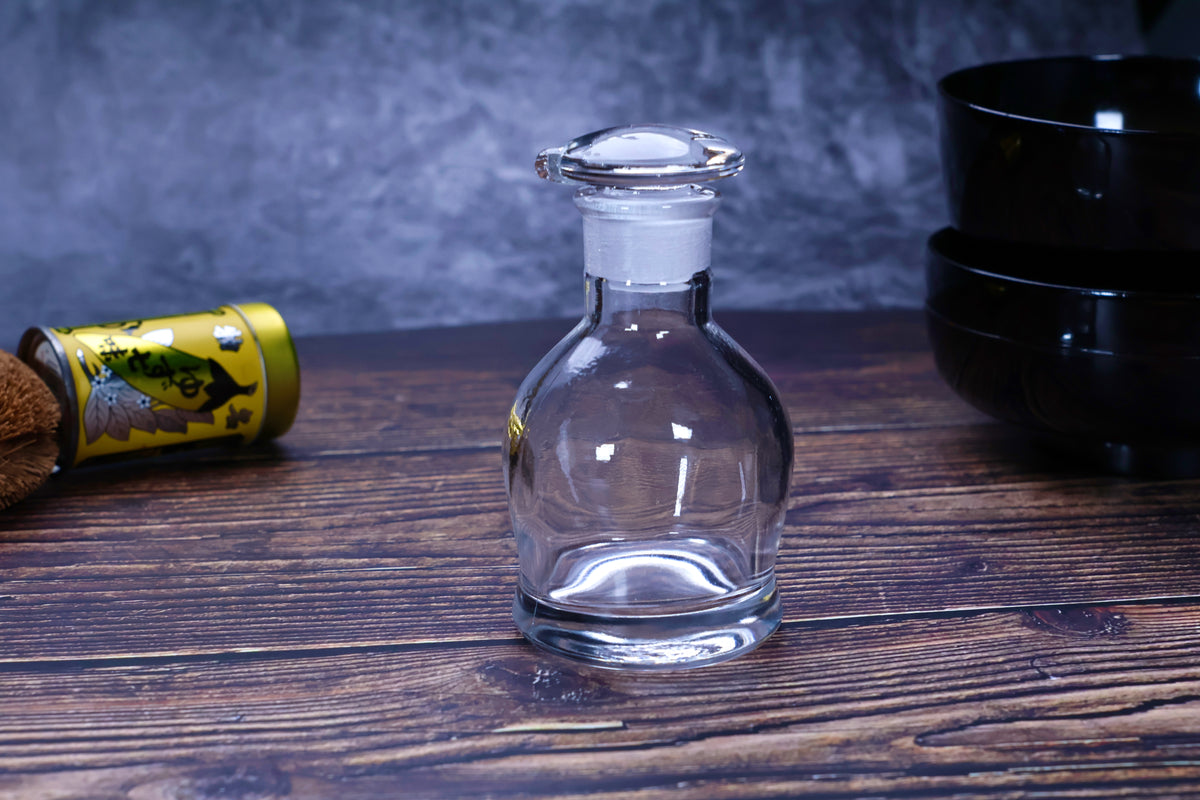 Hirota Glass original soy sauce cruet on dark wood surface styled with Japanese kitchen accessories