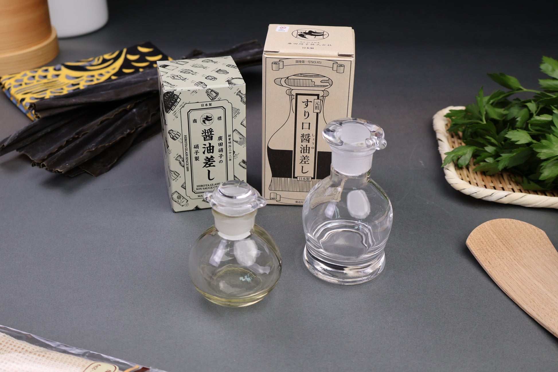 hirota glass company products cruets and product boxes with animated containers hiragana company logo grey background