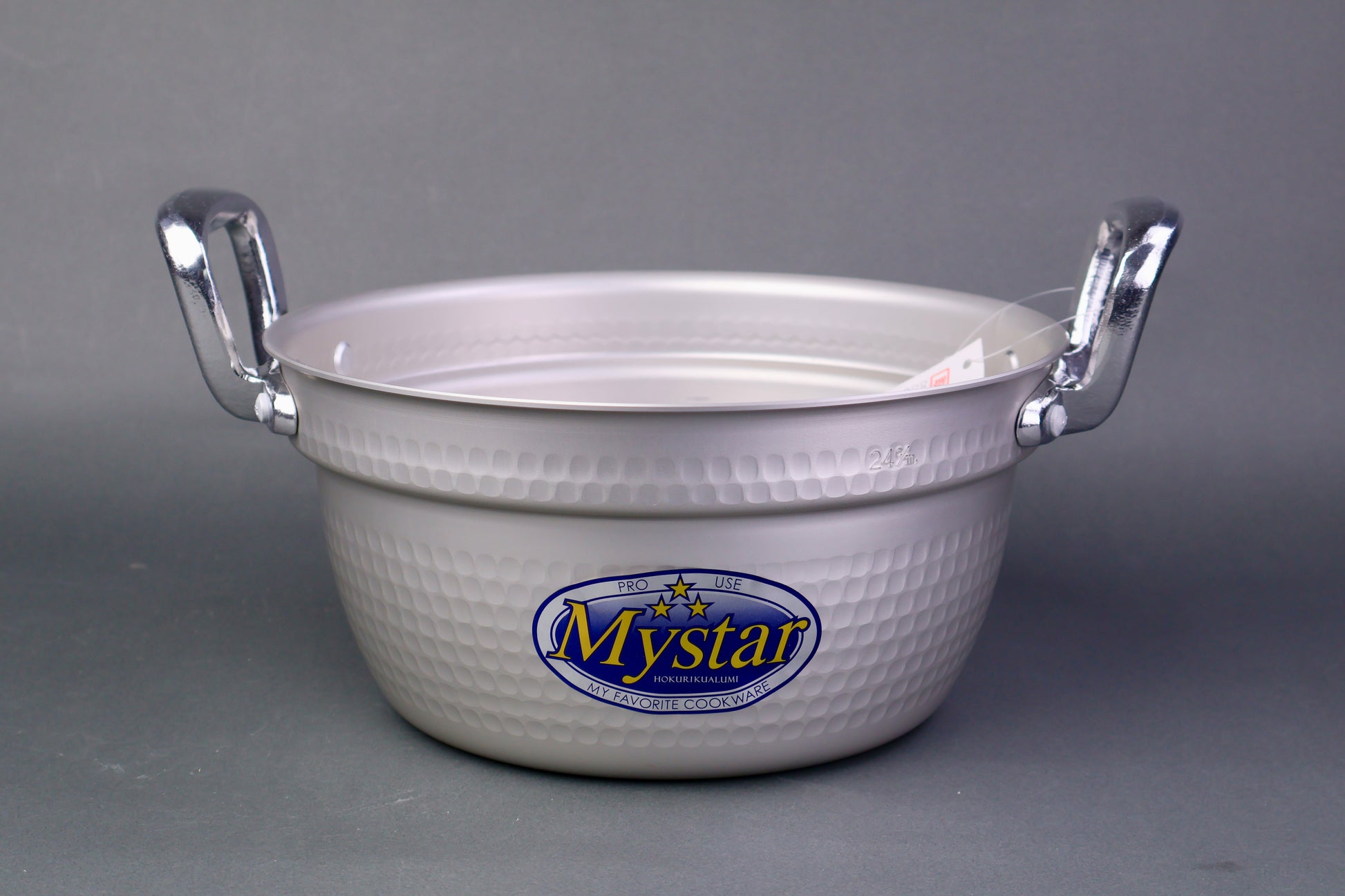 silver aluminum two handled cooking pot for steaming with interior ledge in grey background