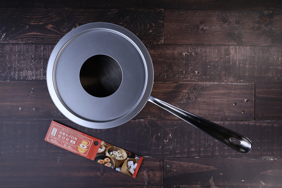 Hokuriku Aluminum steam ring 20cm — seated on single-handle pan, top view with red packaging