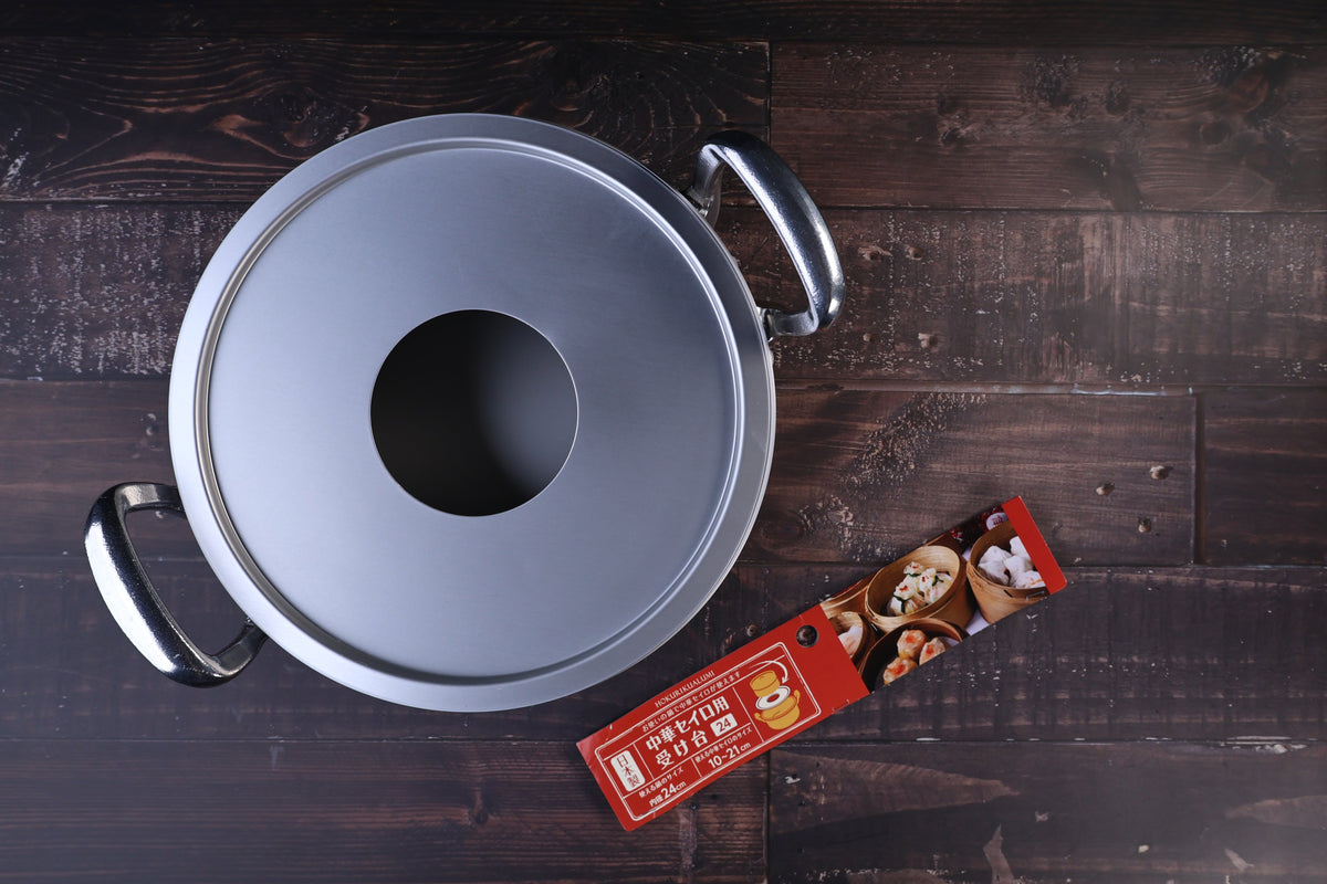Hokuriku Aluminum steam ring 24cm — seated on double-handle pot, top view with red packaging