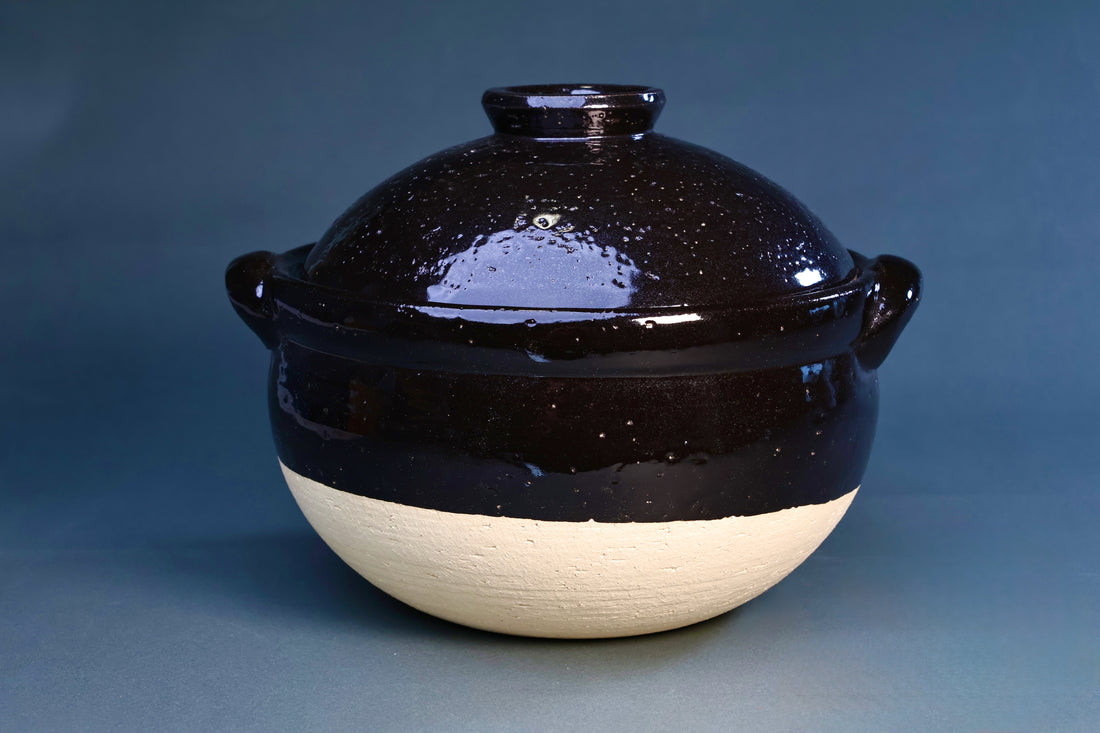 Iga Yaki rice donabe front view showing black speckled glaze on top and natural unglazed clay base