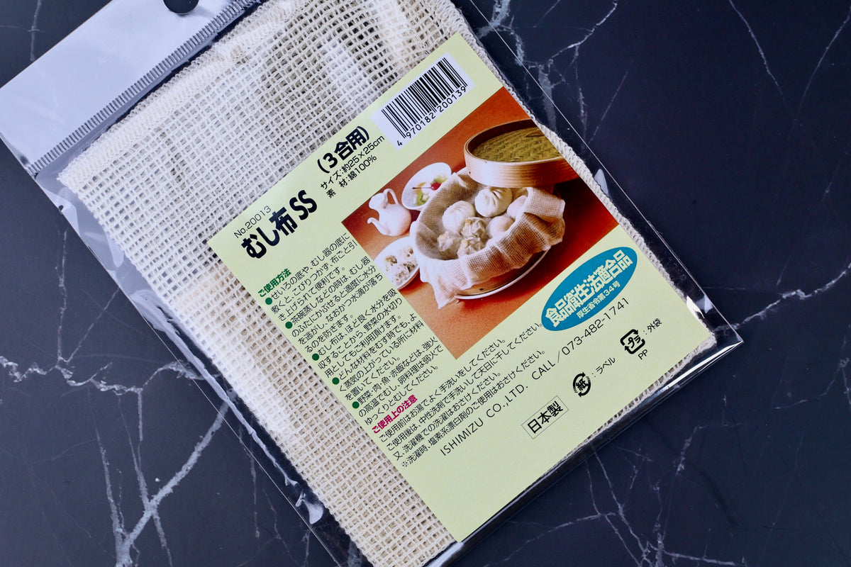 Ishimizu steamer cloth SS 25x25cm packaging angled on marble, むし布SS label and cotton weave visible