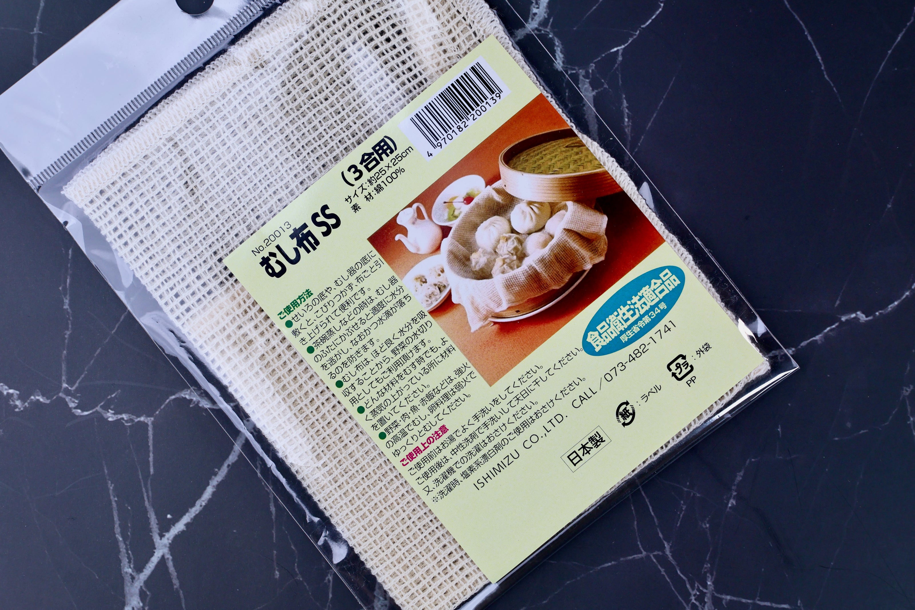 Ishimizu steamer cloth SS 25x25cm packaging angled on marble, むし布SS label and cotton weave visible