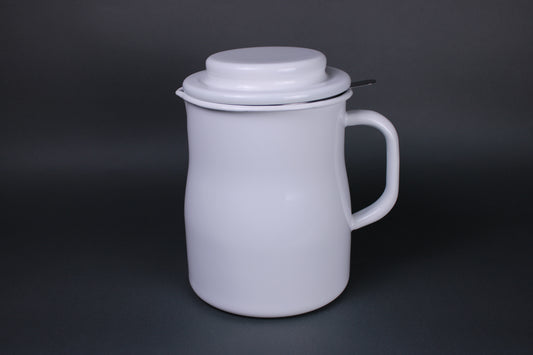 profile shot of deep white glazed oil pot with sturdy lid large handle and metal insert for oil filter sitting in contrast to dark grey background