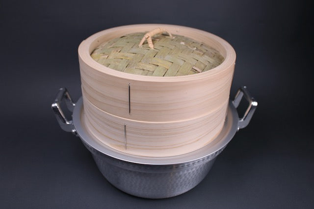  aluminum hammered surface two handled twenty four cm stepped pot with handmade bamboo steamer with kiso hinoki body and aluminum steam ring by hokuriku aluminum with grey background