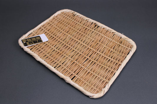 bright brown woven bamboo plate from Sado Japan with grey background
