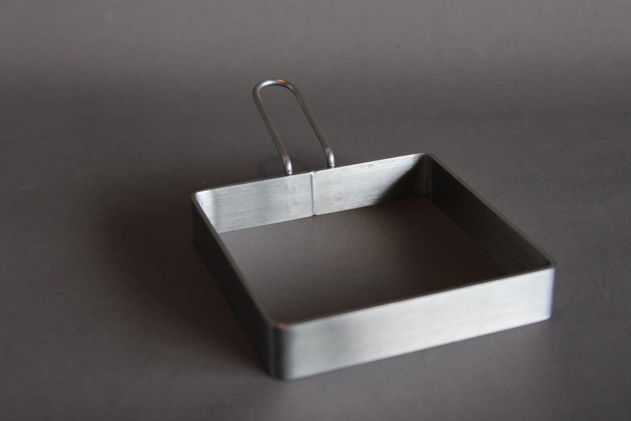 japanese kitchenware sandwich guide made of stainless steel shown with grey background