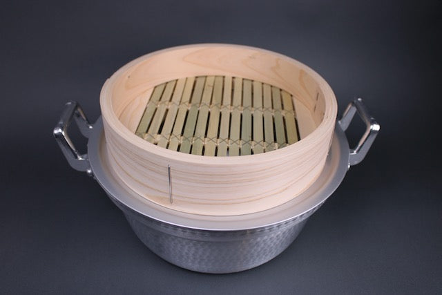  dantsuki aluminum seiro pot with handmade bamboo steamer base with wide slats in grey background