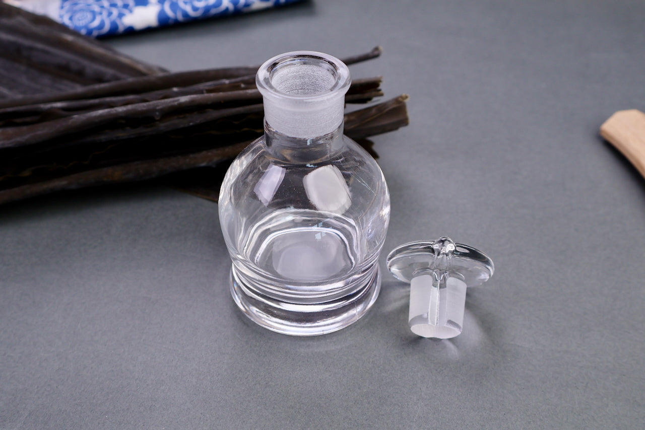 hirota glass soy sauce cruet in front of combo and decorative towel grey background