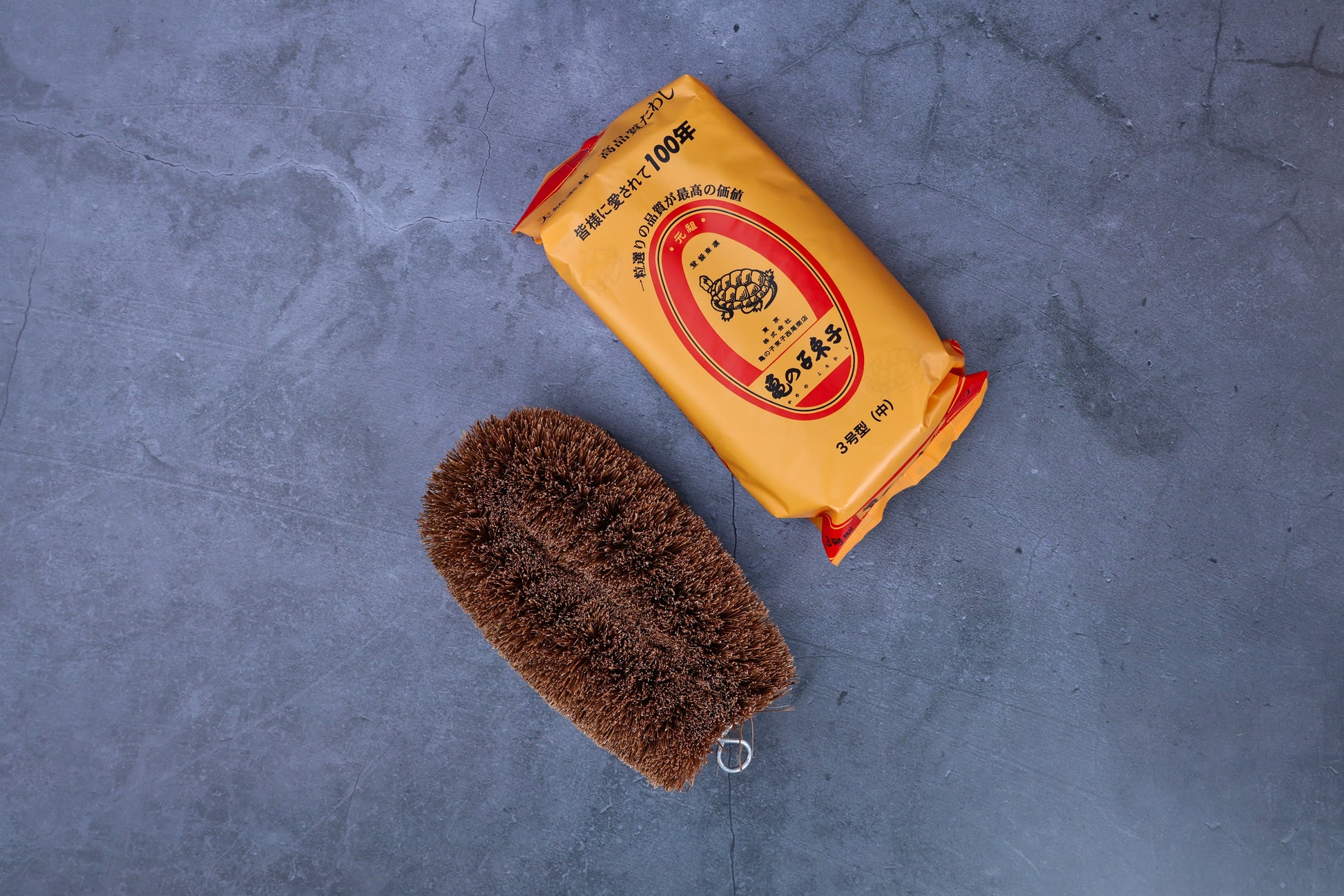 Kamenoko Tawashi No. 3 medium scrub brush — brush and original Japanese packaging flat lay