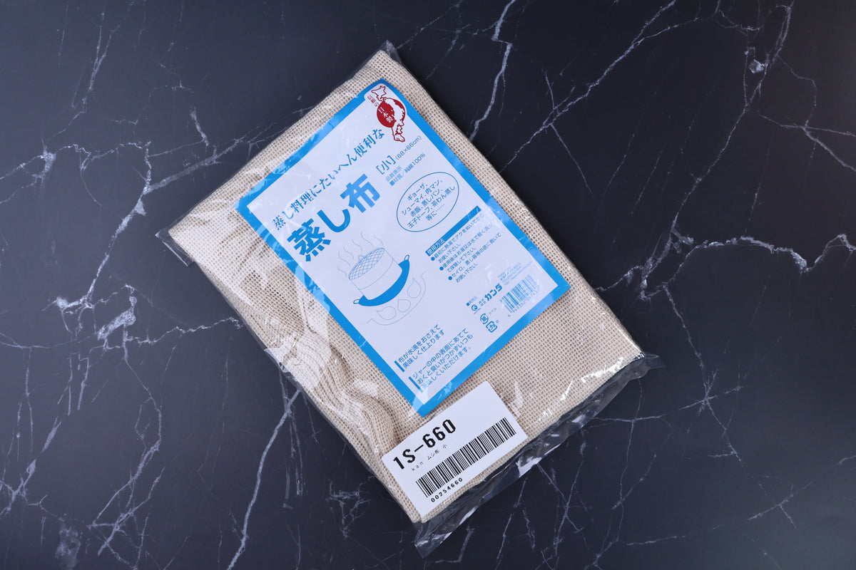 Kanda steamer cloth 蒸し布 small packaging angled on marble, showing blue label and cotton weave through clear plastic