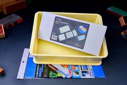 frontal shot of kitchen chef knife sharpening kit with suehiro multi rack hasegawa non slip mat and yellow open box with dark grey blue background 