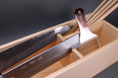 detailed image shows wood box with sections to hold japanese knives and copper grater and cooking chopsticks sitting in front of grey background