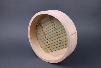 frontal interior shot base of bamboo kiso hinoki steamer extra thick walls bamboo slats wrapped with stainless steel wire for durability in grey backdrop