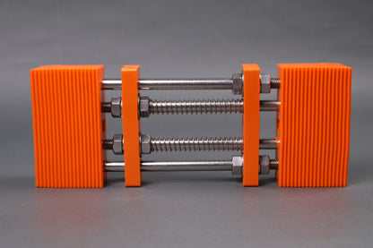 marie whetstone holder rectangular shape orange in color with internal metal springs in grey background