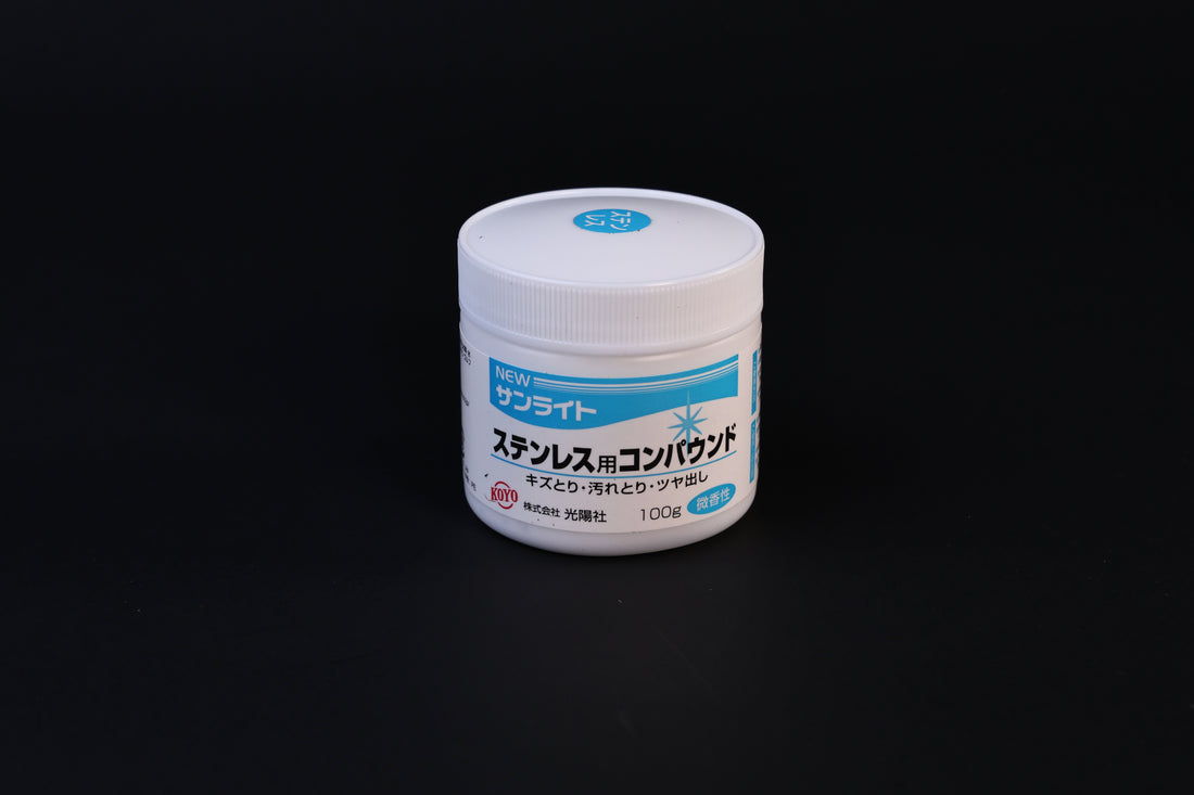 Koyo New Sunlite stainless steel polishing compound 100g jar with blue label shown front-on against a dark background