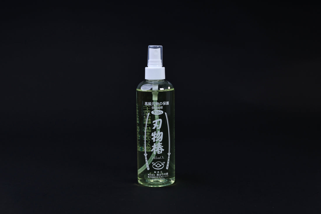 Kurobara tsubaki camellia oil 245ml spray bottle standing upright, Japanese label fully visible on black background