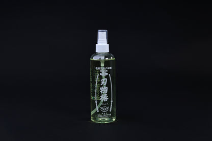 Kurobara tsubaki camellia oil 245ml spray bottle standing upright, Japanese label fully visible on black background