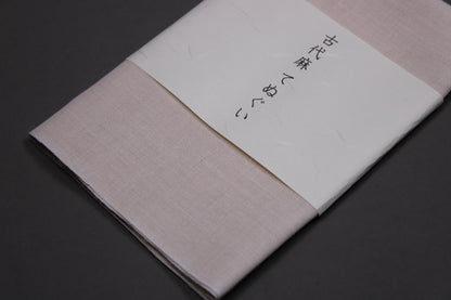 inen towel tenugui showing angled shot of linen towel and brand name on paper wrapper