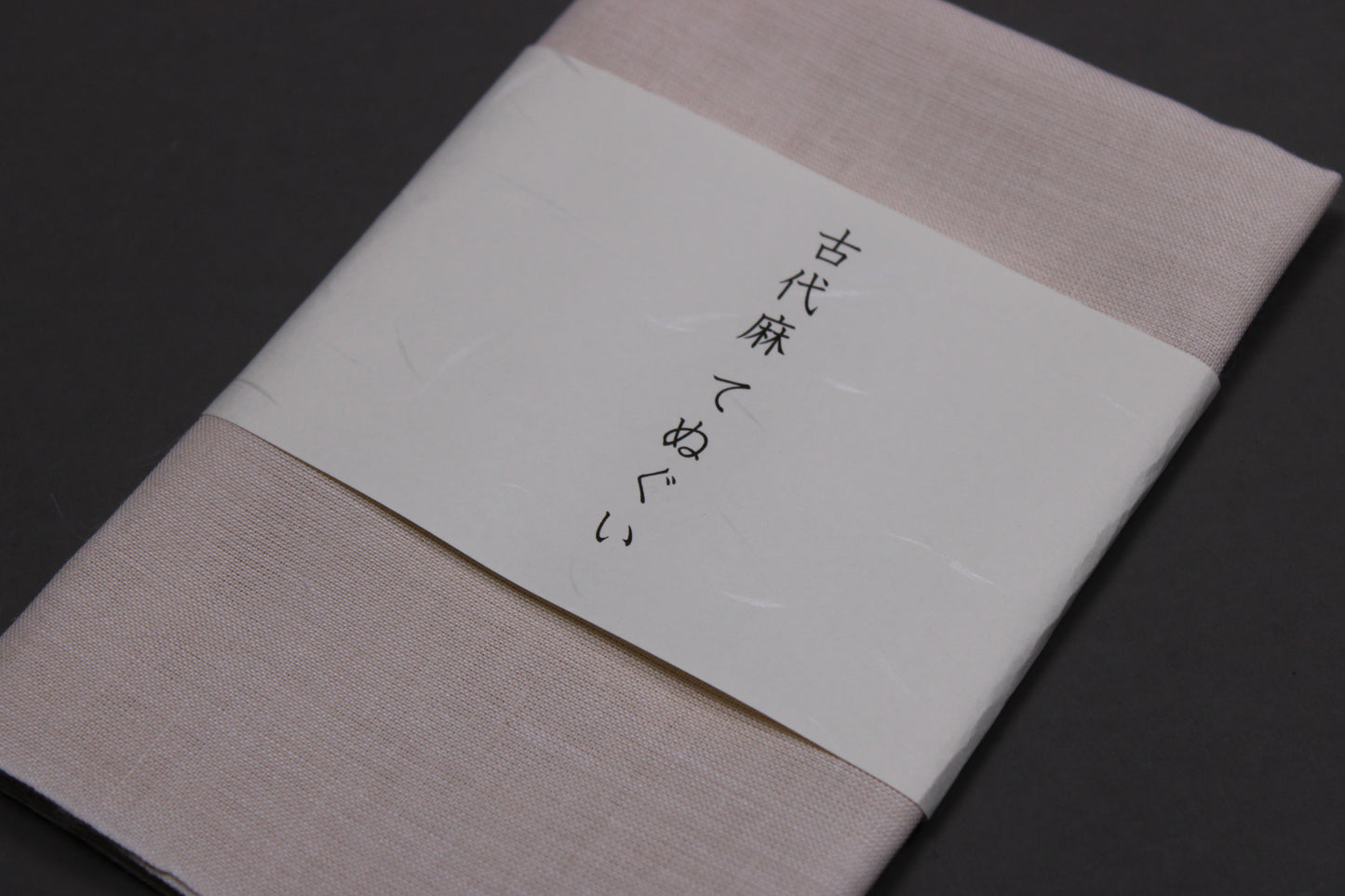 closeup shot tenugui linen towel okai mafu texture and paper displaying brand name